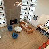 Birds eye view of open format living and dining room with wood look tile flooirng