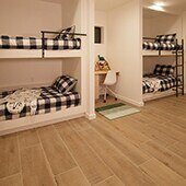 Small bedroom featuring built-in bunk beds with black and white check accessories.